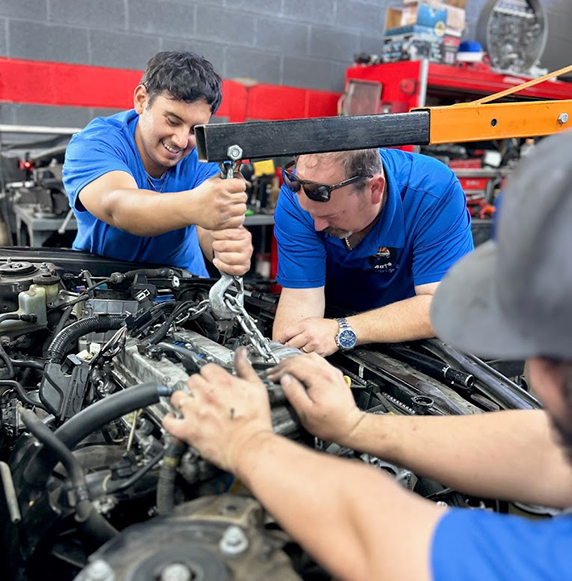 mechanics working on car